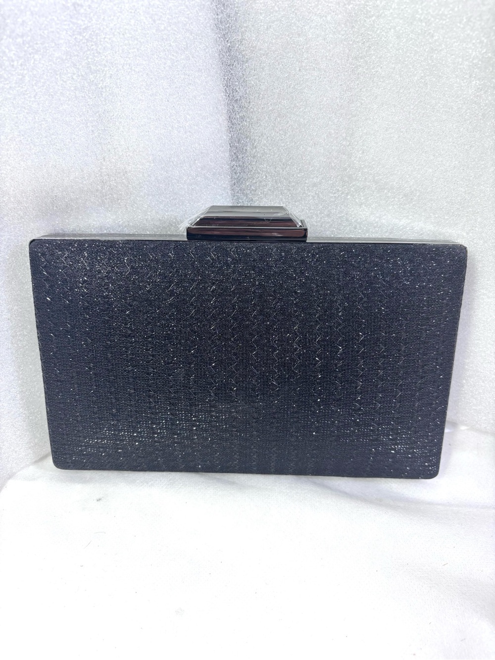 Sondra Robert’s Black Shiny Clutch.